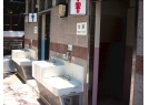 The low-level wash basins outside the public toilet